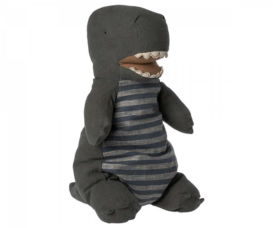A plush toy dinosaur resembling a Maileg Large Dark Green Gantosaurus Dinosaur, specifically a T-Rex, with a dark gray body and lighter gray horizontal stripes on its belly. It features a large mouth with visible white teeth and small stubby arms and legs, crafted from soft mix fabric for extra cuddliness.